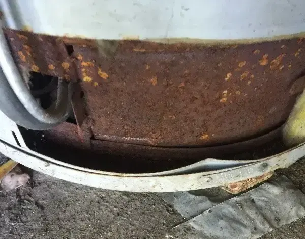 The rusted base of an old water heater tank, a warning sign that a Ramsey homeowner should not ignore