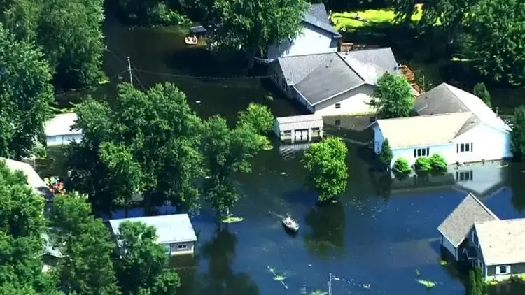 Aerial view of river flood water surrounding houses and trees, river and spring flood cleanup in Anoka